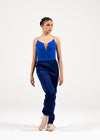 Adult dancer wearing navy blue heat retention warm-up pants in a relaxed stance.