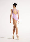 Back view of dancer wearing a lavender leotard walking in ballet shoes