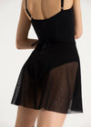 Dancer wearing a black wrap skirt over a leotard showing back view