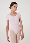 Young dancer modeling light pink cap sleeve leotard front view.