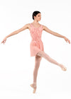 Adult dancer mid-leap wearing pink mesh ballet skirt with soft drape.