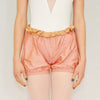 Dancer wearing peach two-way trash bag dance shorts worn over tights