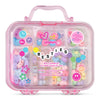 A pink translucent plastic bag charm kit case with a handle, filled with pastel-colored bag charms and surrounded by decorative stickers and a central 'BESTIES' word cloud. The product is photographed on a clean white background.
