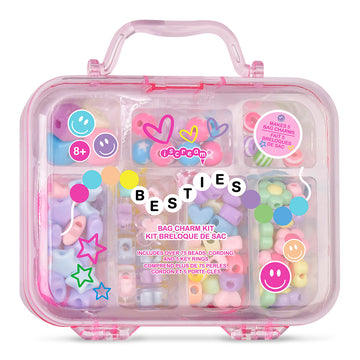 A pink translucent plastic bag charm kit case with a handle, filled with pastel-colored bag charms and surrounded by decorative stickers and a central 'BESTIES' word cloud. The product is photographed on a clean white background.
