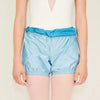 Dancer wearing light blue two-way trash bag dance shorts worn over tights