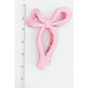 Pink Love and Repeat matte bow hair claw shown upright