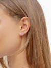 Model wearing small enamel stud earring in ear
