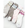Assorted Love and Repeat plush socks in neutral and pastel colors with chevron patterns