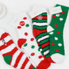 Assorted Christmas plush socks with red, green, and white holiday patterns