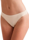 Model wearing a nude low-rise invisible thong with seamless edges