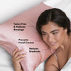 Model lying on a blush satin pillowcase with smooth, shiny fabric visible
