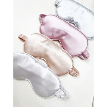 Love and Repeat satin sleeping eye masks in champagne, white, pink, and grey