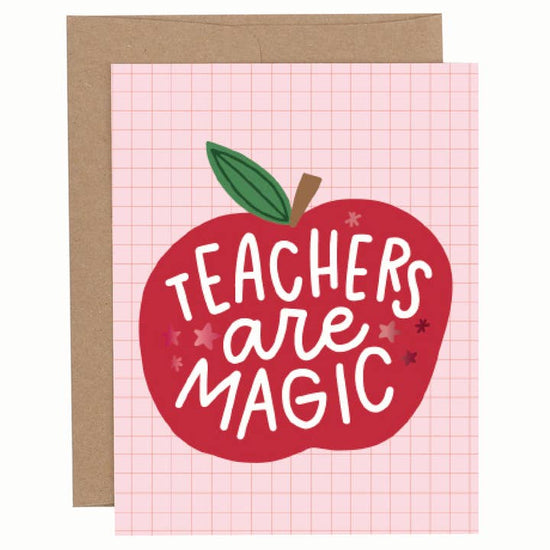Apple-themed greeting card with red foil “Teachers Are Magic” text on a pink background, shown with a kraft envelope