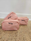 Pink round cosmetic pouch with embroidered FTT logo