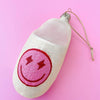 Close-up of a pink smiley face slipper ornament showing the smiling face detail.