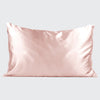 Blush satin pillowcase sitting upright