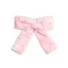 Sweet Wink pink velvet hair bow with scattered pearl accents and ribbon-covered alligator clip