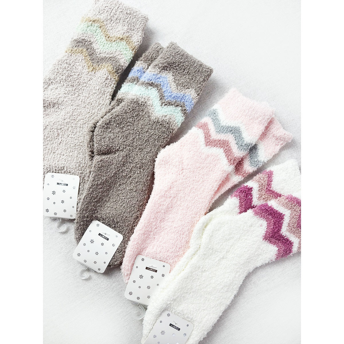 Assorted gray, pink, and white Love and Repeat chevron plush socks
