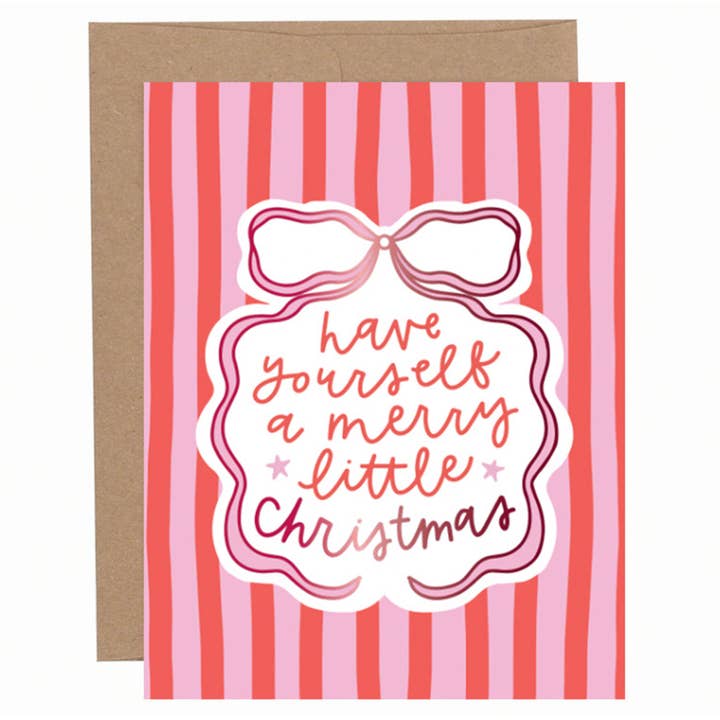 Red and pink striped Christmas greeting card with a bow illustration and hand-lettered “Have yourself a merry little Christmas” text, shown with a kraft envelope