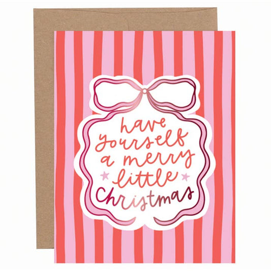 Red and pink striped Christmas greeting card with a bow illustration and hand-lettered “Have yourself a merry little Christmas” text, shown with a kraft envelope