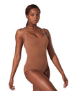 Model wearing a mocha camisole foundation leotard with clear adjustable straps and scoop front