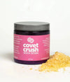 Container of Covet Crush rock rosin with spilled rosin pieces beside it
