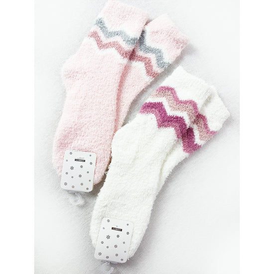 Pink and white Love and Repeat plush socks with colorful chevron patterns
