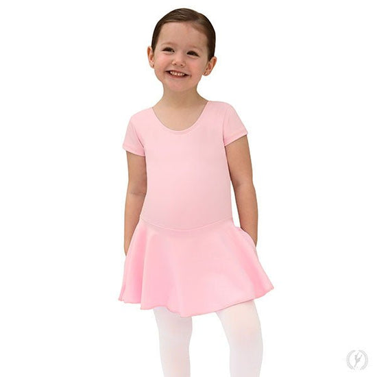 Young dancer wearing a pink short sleeve microfiber dance dress standing with arms relaxed.