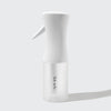 White continuous mist spray bottle standing upright with minimal branding