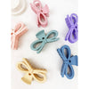 Pastel bow hair claw clips shown from above with knotted bow detail visible