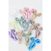 Assorted pastel Love and Repeat bow hair claws displayed together