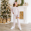 Young girl modeling a coordinating outfit with pink velvet bow accessory