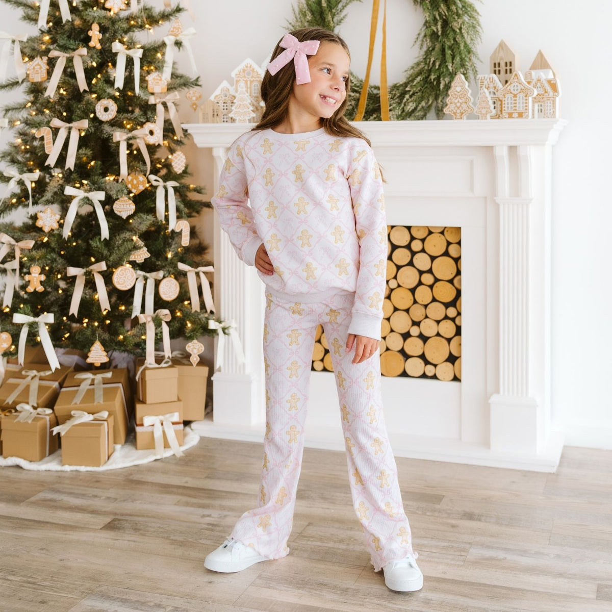 Young girl modeling a coordinating outfit with pink velvet bow accessory