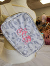 Grey cheetah print belt bag with hot pink Peace Love Dance embroidery on display