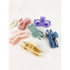 Assorted pastel jumbo bow hair claw clips displayed on a white surface