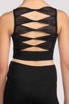 Close-up of twist-back mesh design on child dance crop top