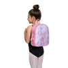 Young dancer wearing a pink and pastel dance backpack on her back