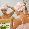 Model adjusting the fit of a satin-lined flexi shower cap