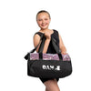Young dancer wearing a black dance bag over one shoulder