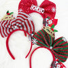 Assorted Christmas bow headbands in red and green displayed together on a white surface