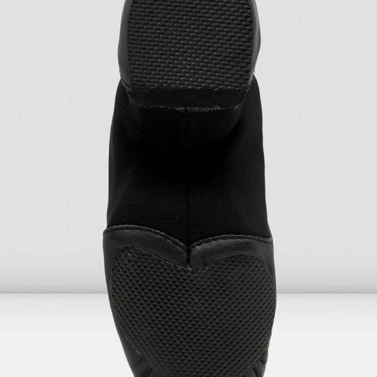 Black slip-on shoes with textured sole on a white background