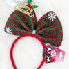 Close-up of a red and green decorated Christmas bow headband
