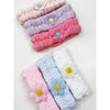 Folded daisy spa headbands shown in multiple soft colors