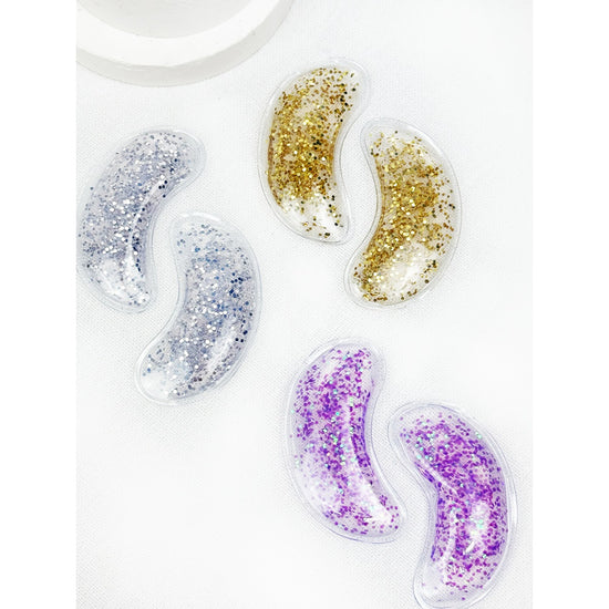 Love and Repeat reusable under-eye gel patches in silver, gold, and purple glitter finishes