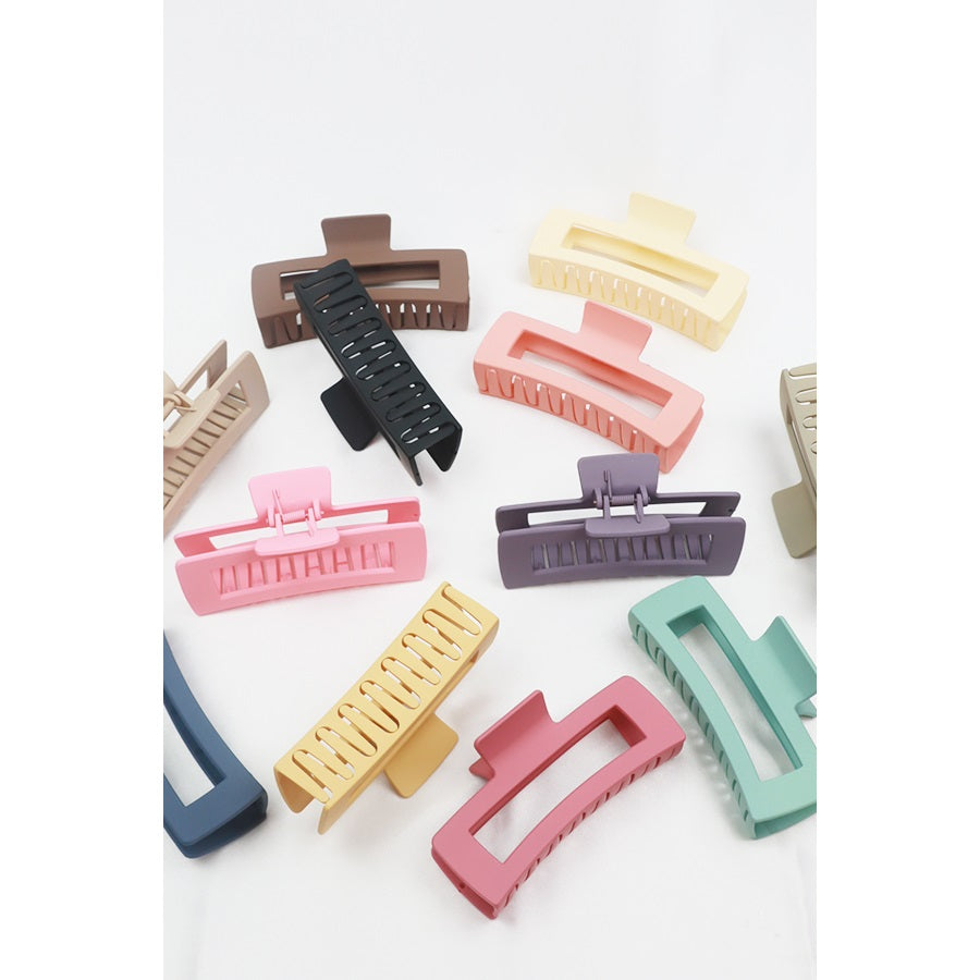 Love and Repeat matte hair claws displayed with assorted colorful hair accessories