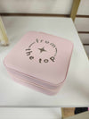 Pink jewelry box shown at an angle highlighting its structured shape and zipper detail
