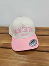 Front view of a cream baseball cap with pink bill and pink “FROM THE TOP” embroidery