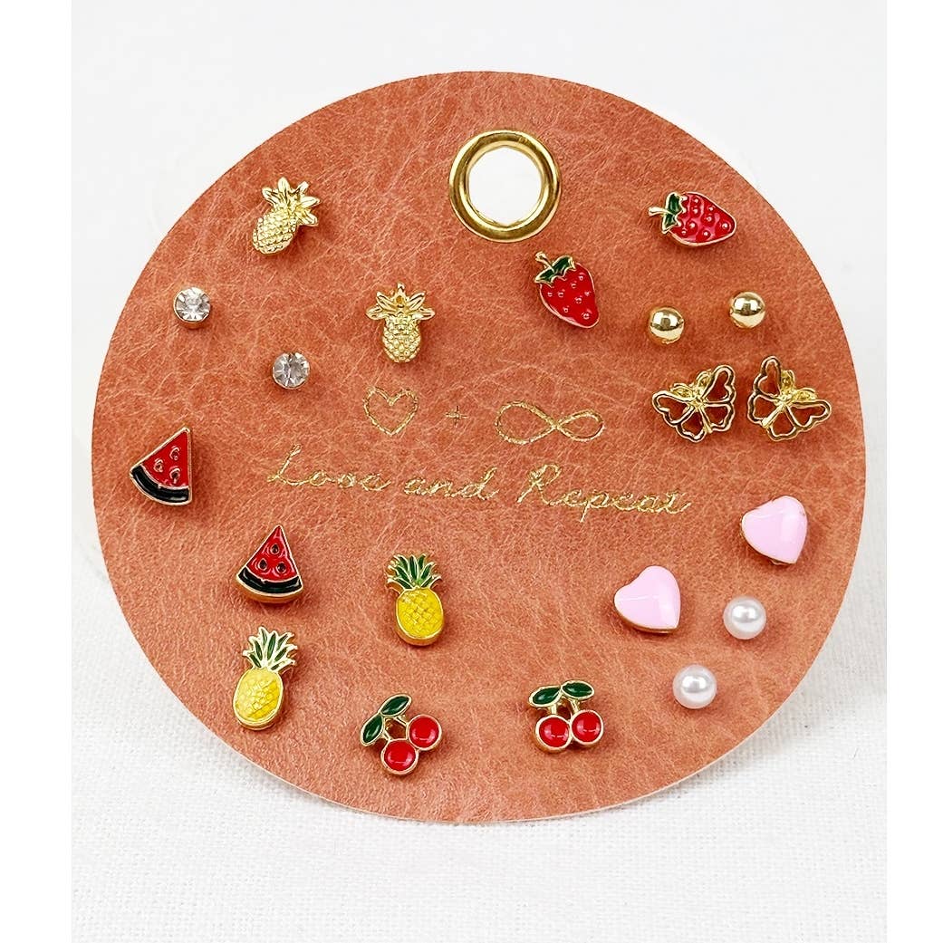 Love and Repeat Everyday Fruity Minimal Earrings featuring assorted gold-tone fruit studs with colorful strawberry, cherry, and miniature fruit designs displayed on a round jewelry card