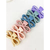 Angled view of pastel bow hair claw clips layered together