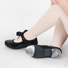 Adult tap shoe shown on dancer’s foot, featuring a black upper and full sole design